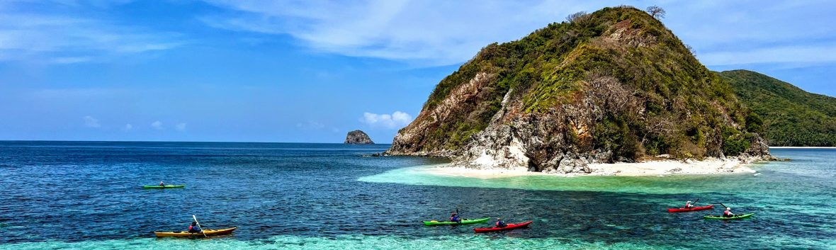 Guide leading a kayaking trip in Coron