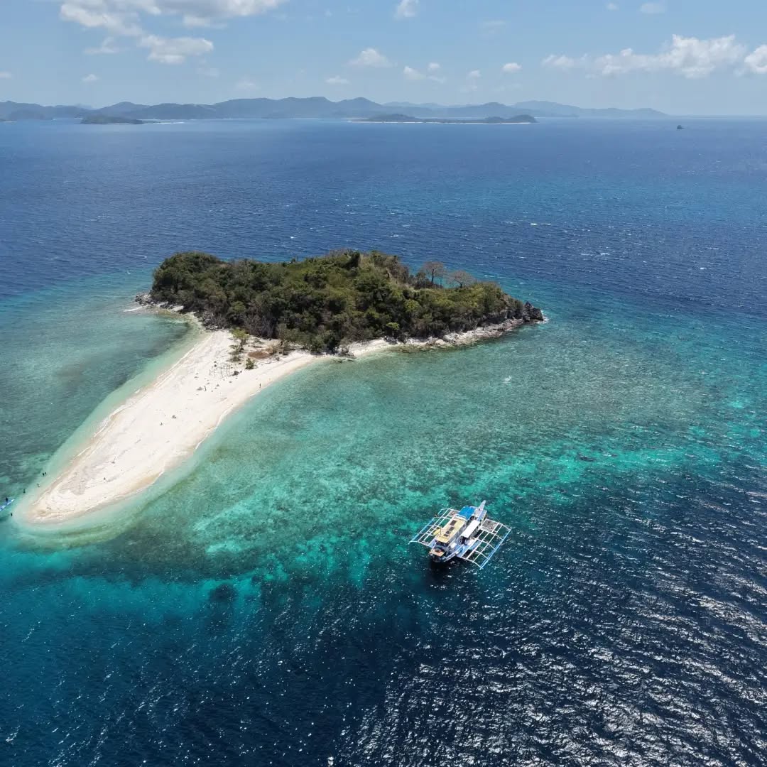 Island hopping expedition boat anchored off Coron Island